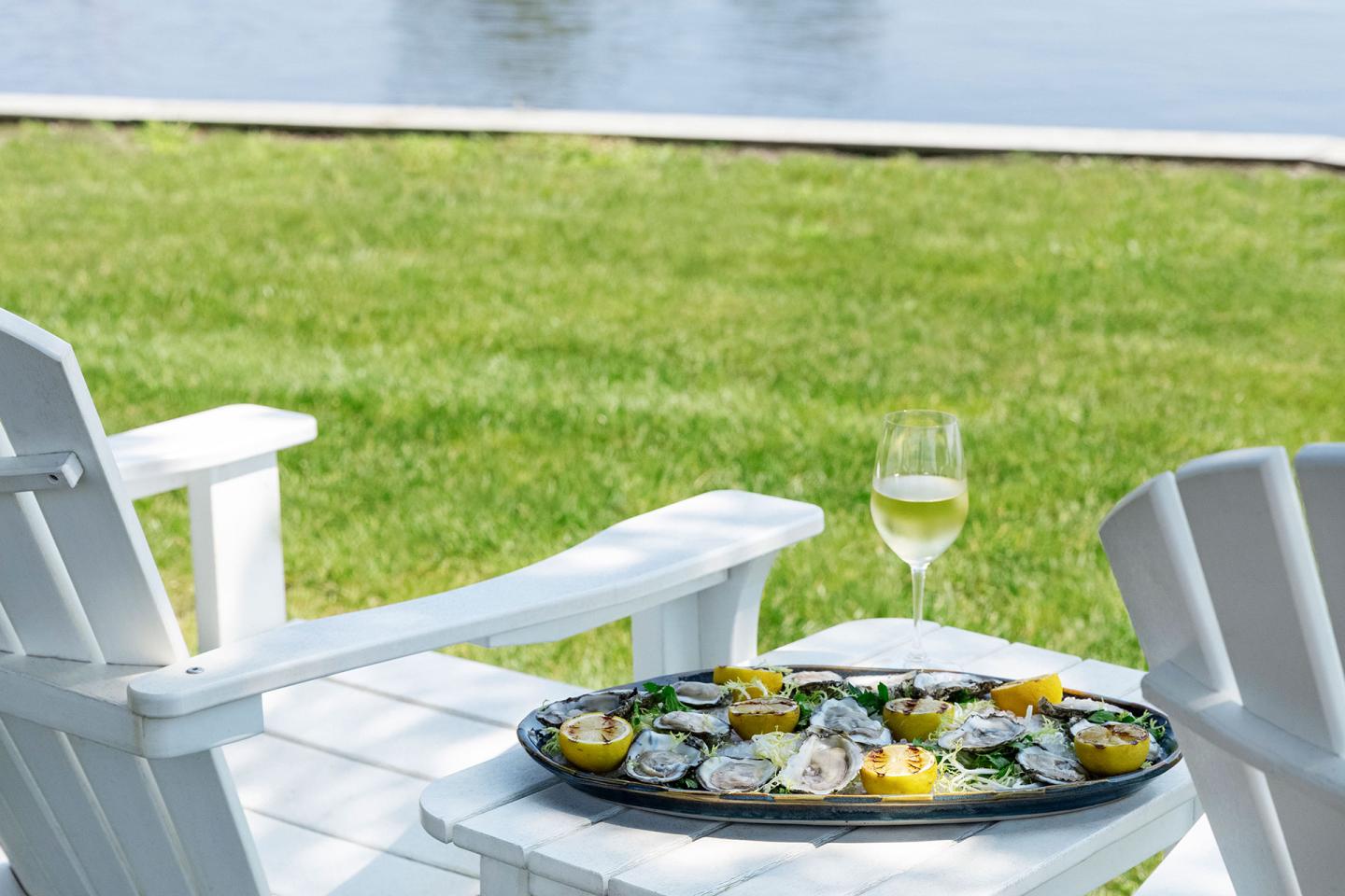 Oyster platter by deck chairs at the ocean
