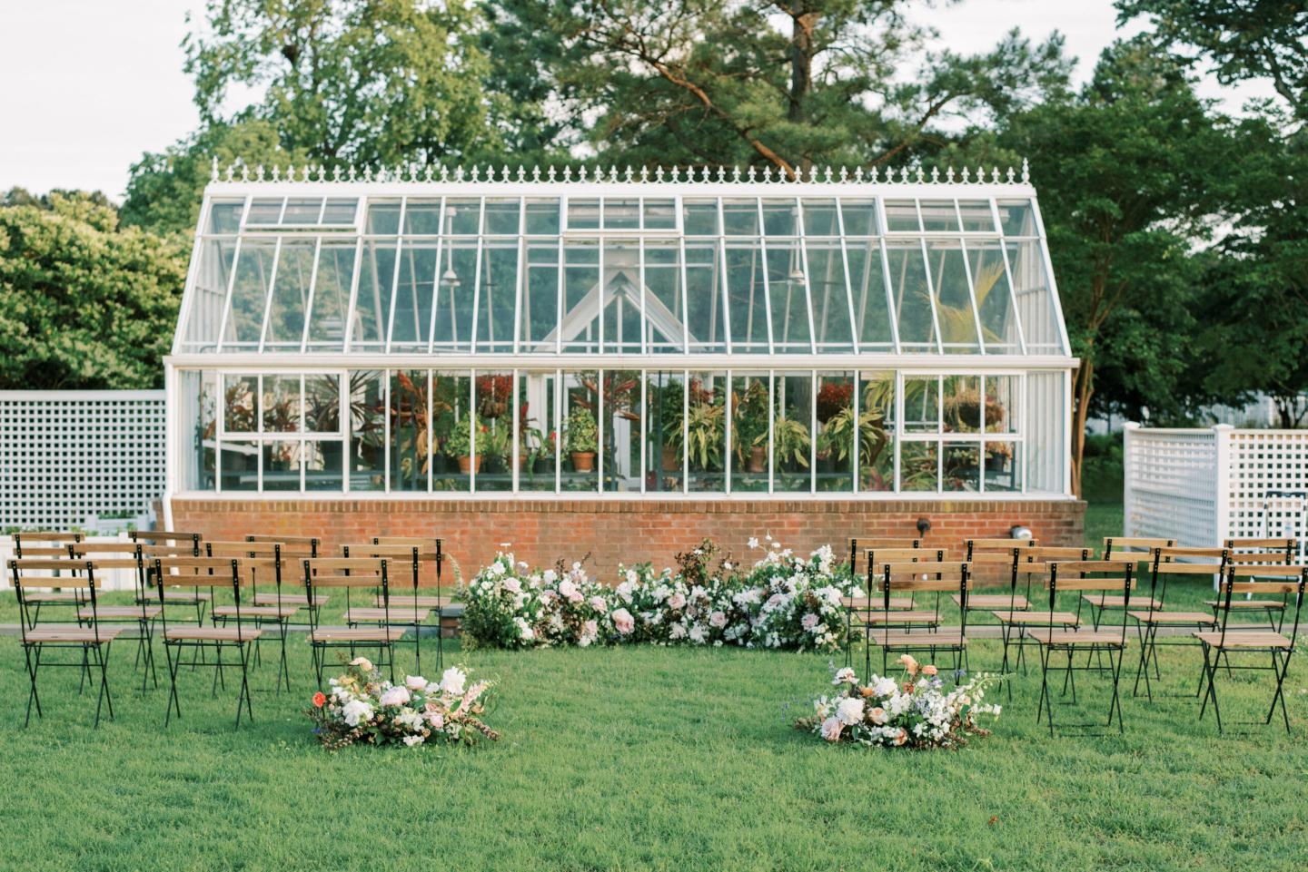 Rows of chairs set by a greenhouse