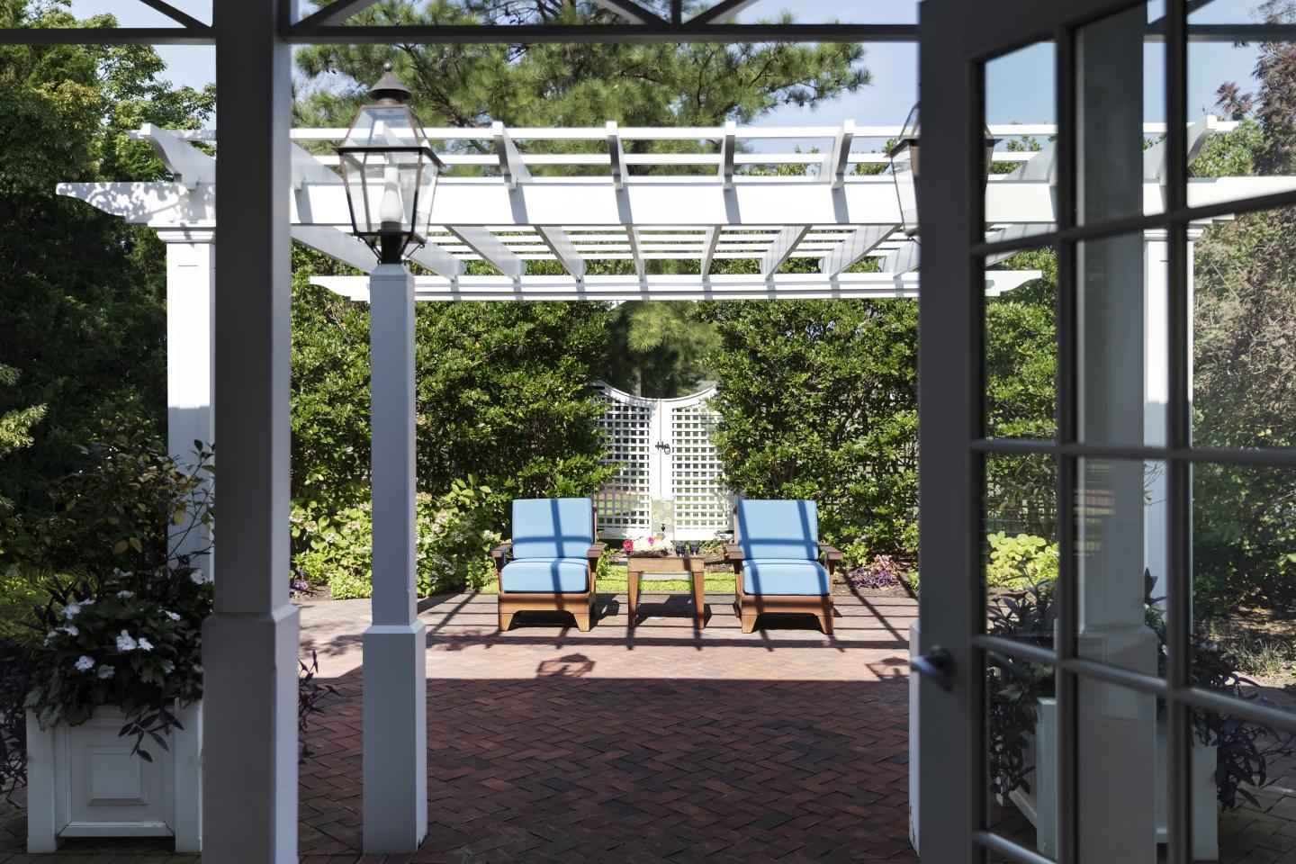 Two chairs on a sunny outdoor area known as the Living Room