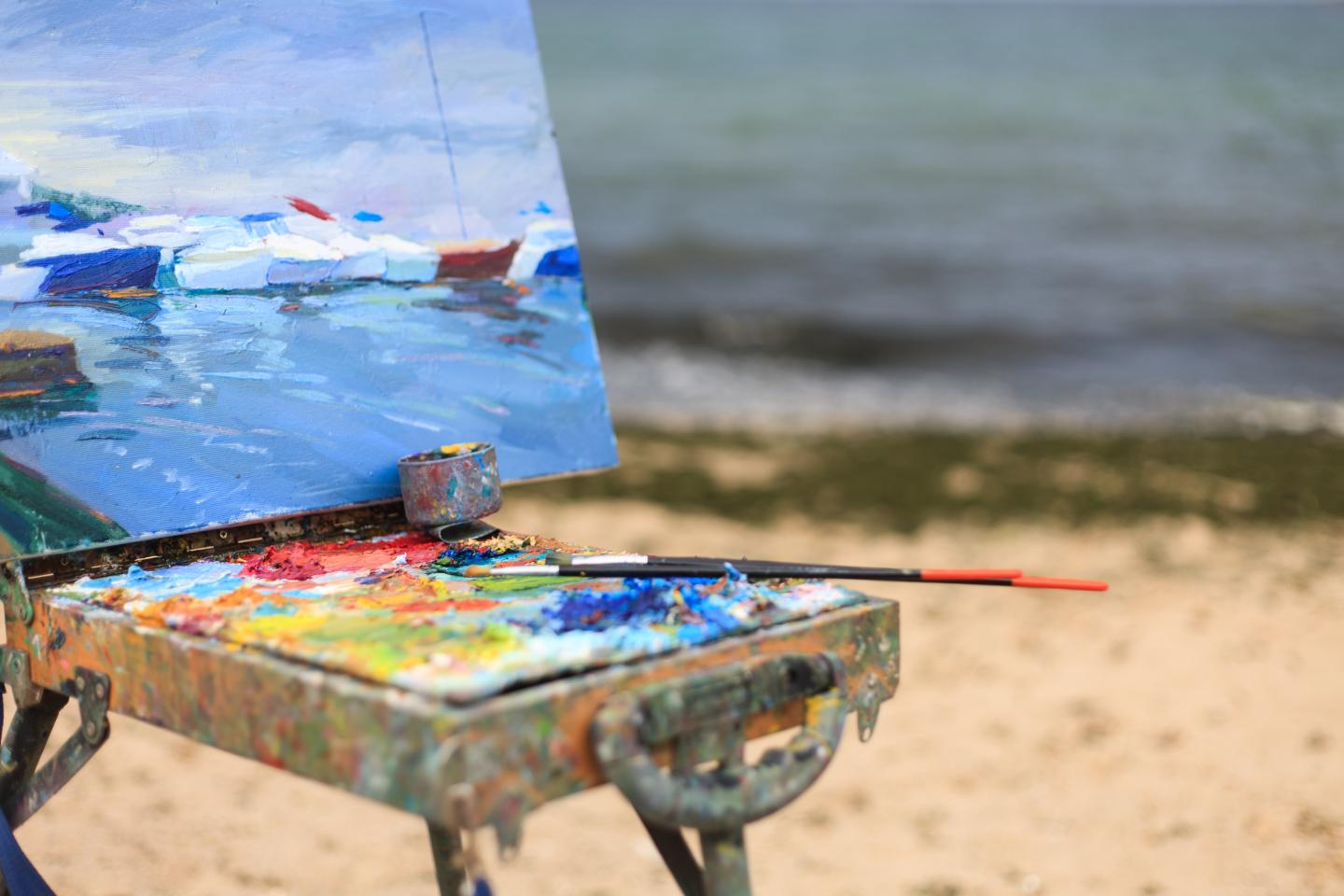 easel with painting and paint