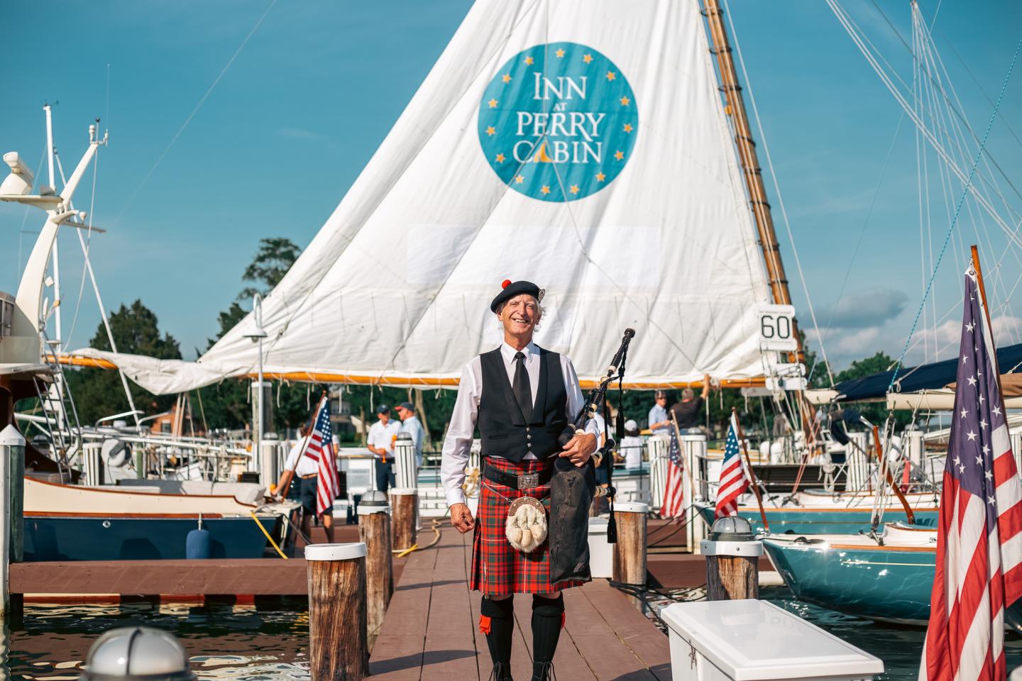 Bagpiper in front of sailboat