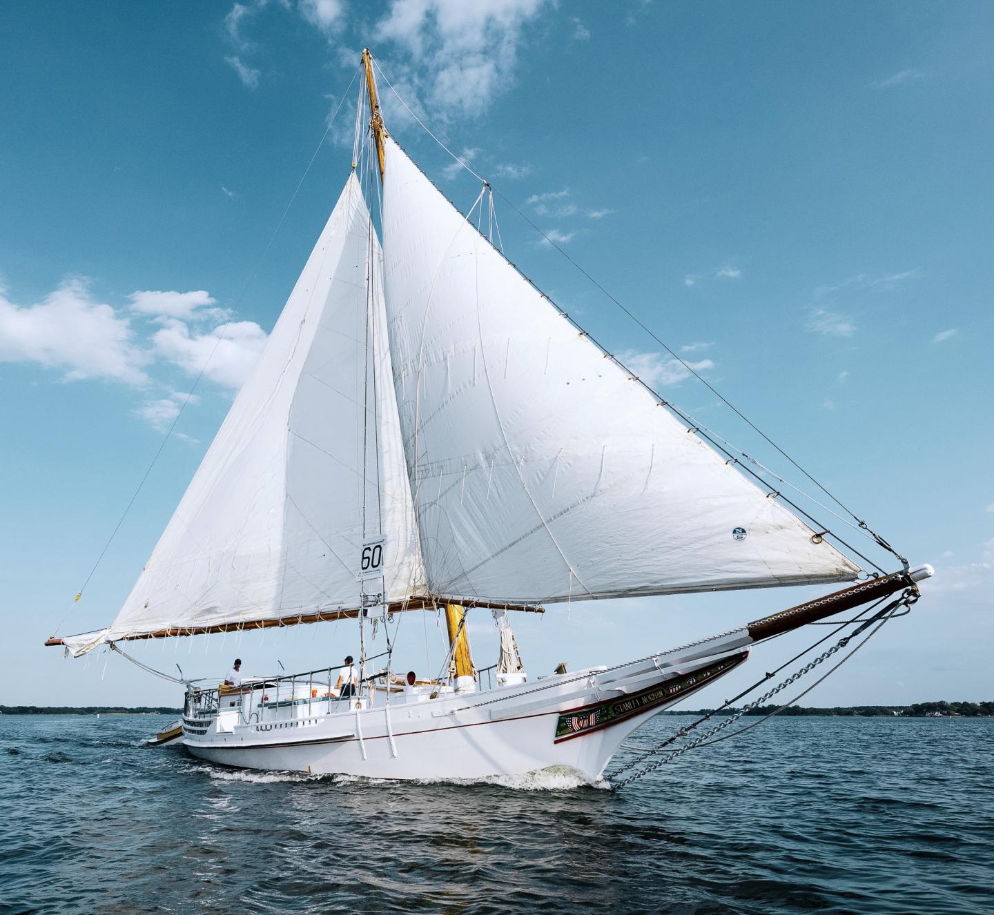 Stanley Norman Skipjack sailing through the pristine bay