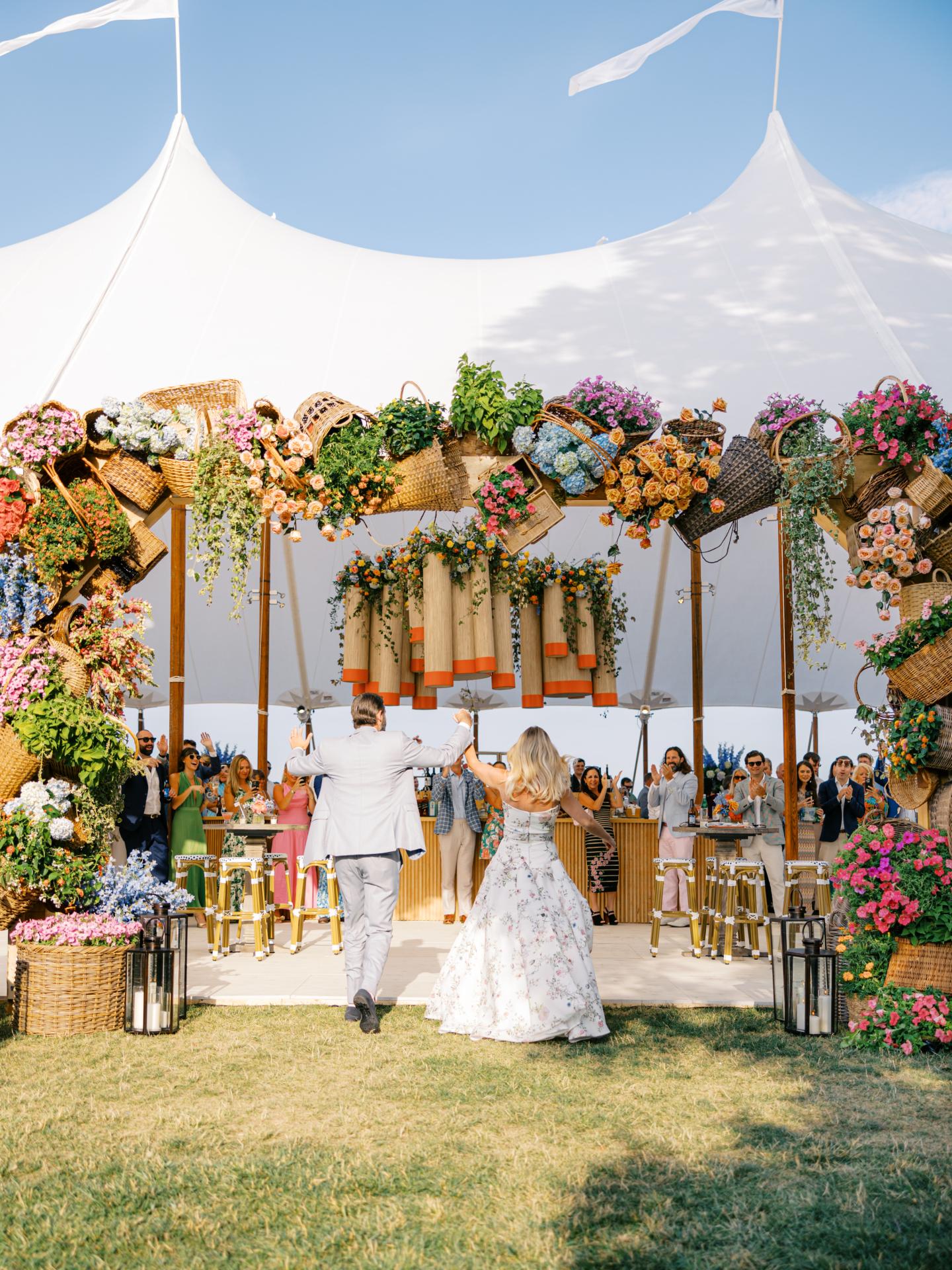 Bride and groom entering their reception tent on The waterfront Pointe