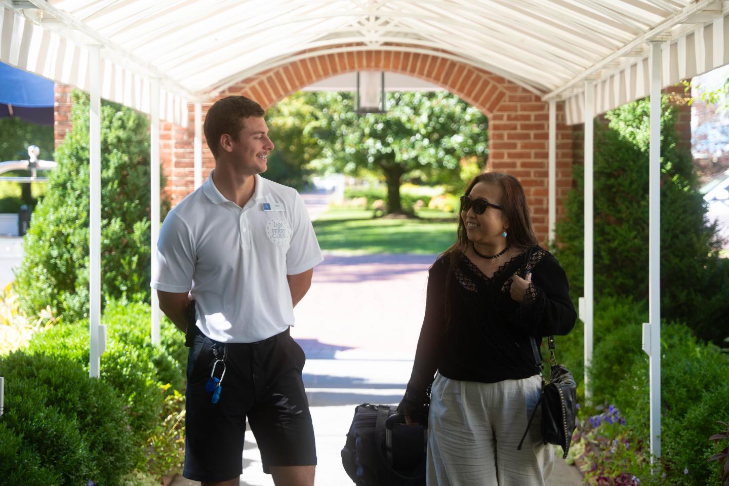 Valet guiding guest to entrance