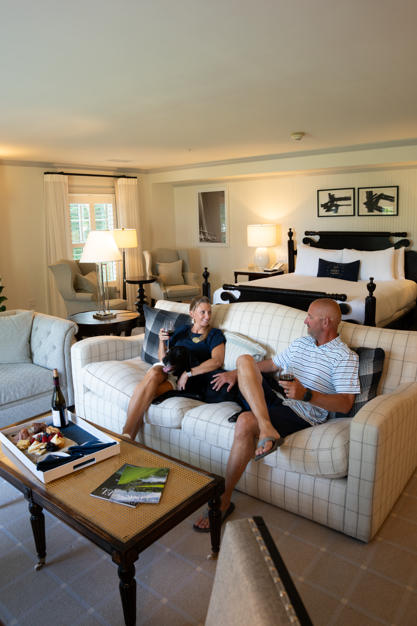 Couple and canine relaxing in suite
