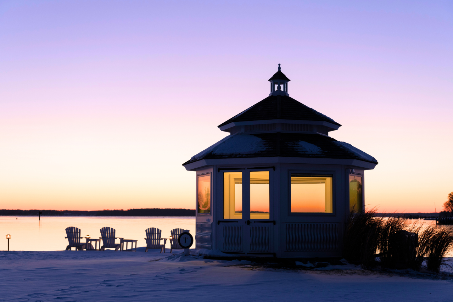Snow covered ground and beautiful winter sunrise overlooking the Miles River