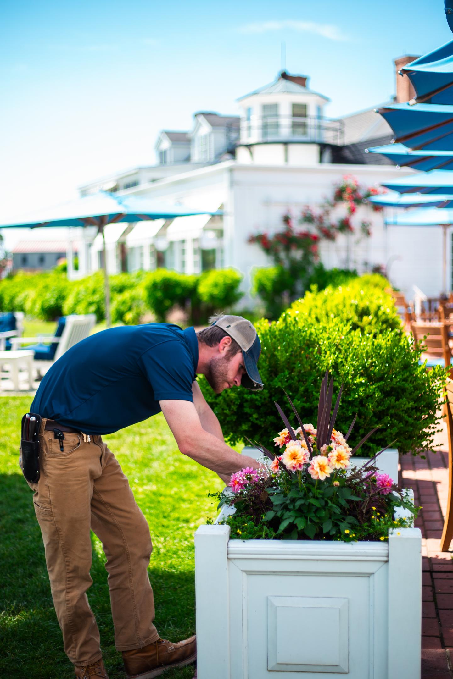 Horticulturist Kyle Mitchell tending to garden boxes on the terrace